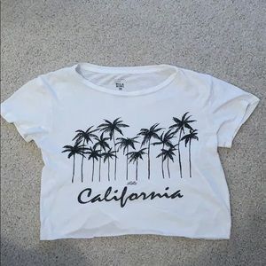 White Billabong top with black graphics.